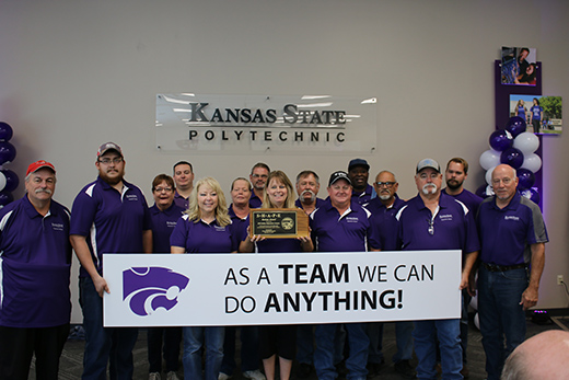 Kansas State University Polytechnic Campus staff members celebrate receiving the Safety and Health Award for Public Employees from the Kansas Department of Labor.