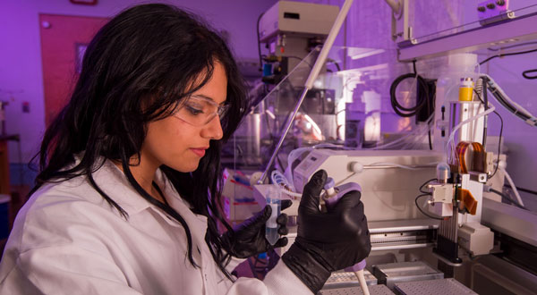 This image shows a woman working in a laboratory. 