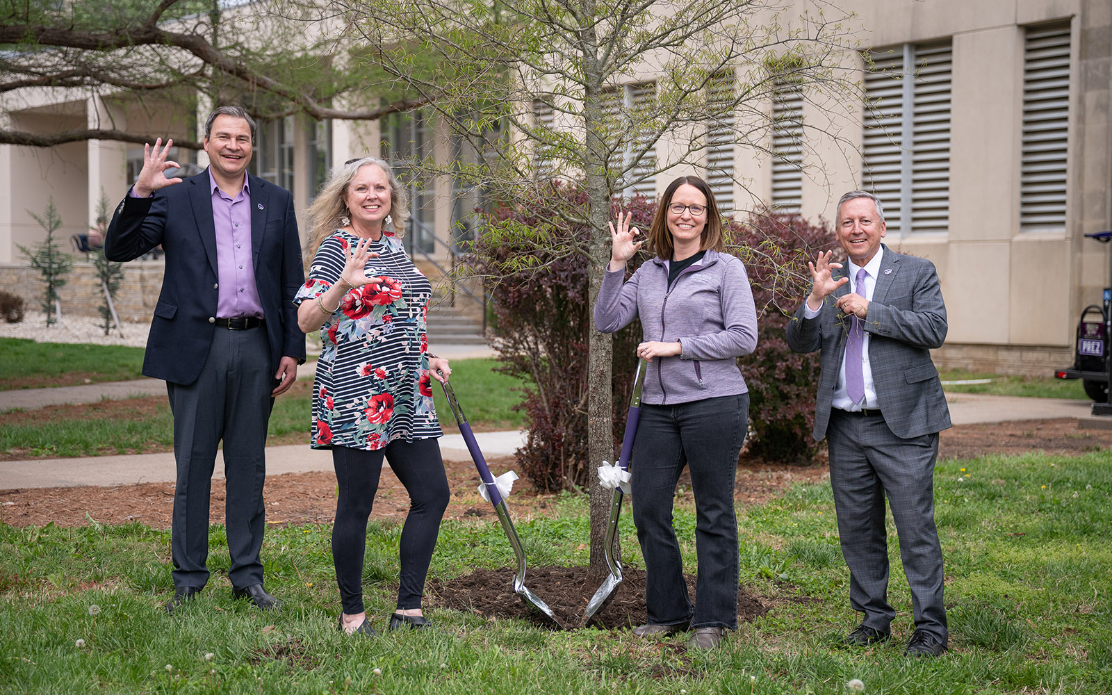 Faculty members, vice president for research and university president planting a tree as a representation of excellent scholarly achievement.