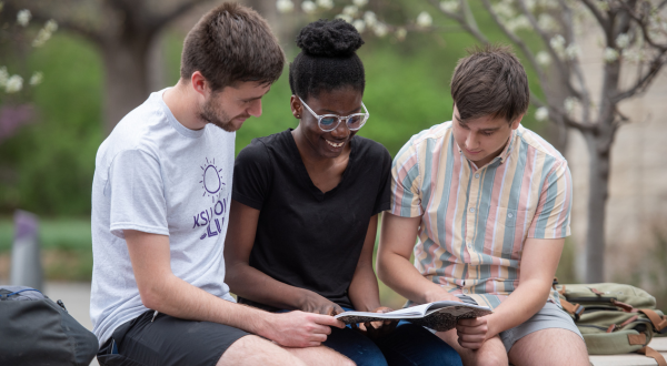 Students on bench reading together