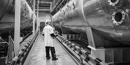 Worker inspecting industrial factory
