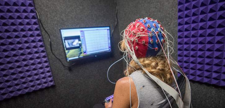 A participant wears an EEG cap