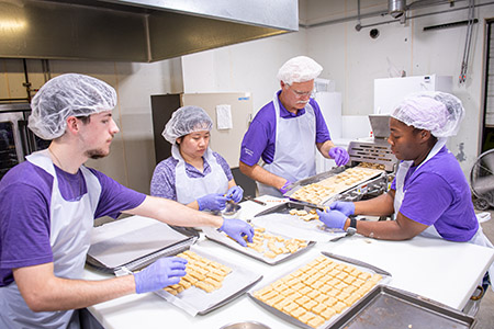 Aldrich and several students prepare K-State-made dog treats and other pet food, which use many kinds of ingredients.