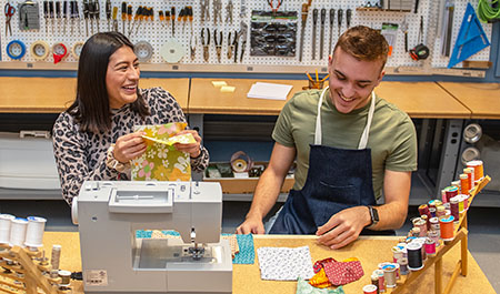 Students use the sewing machines in the makerspace of the Sunderland Foundation Innovation Lab.