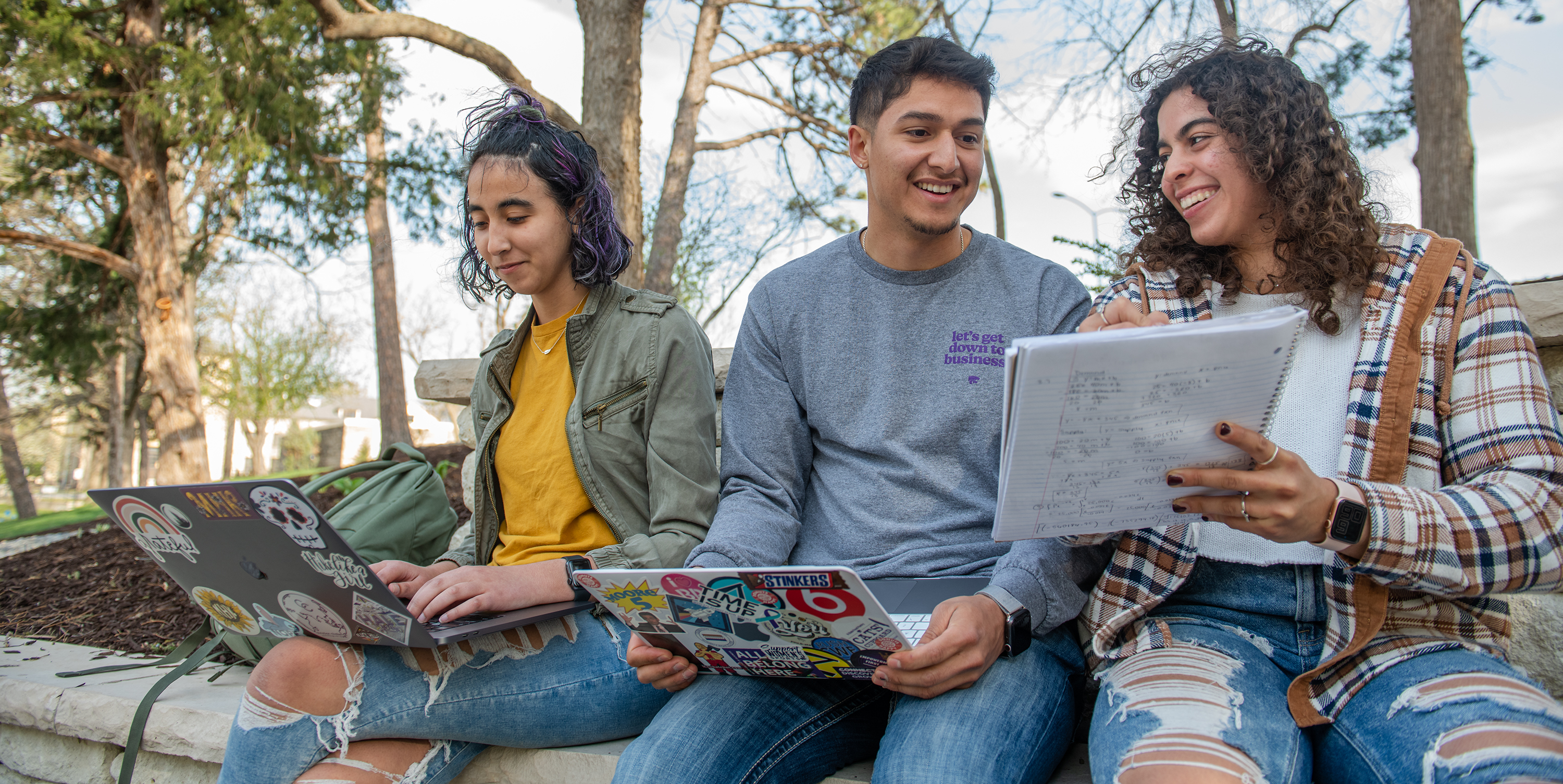 Three students studying outside together