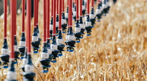 An irrigation pivot runs over western Kansas forage crops