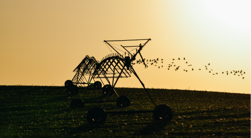 picture of an irrigation pivot at sunset