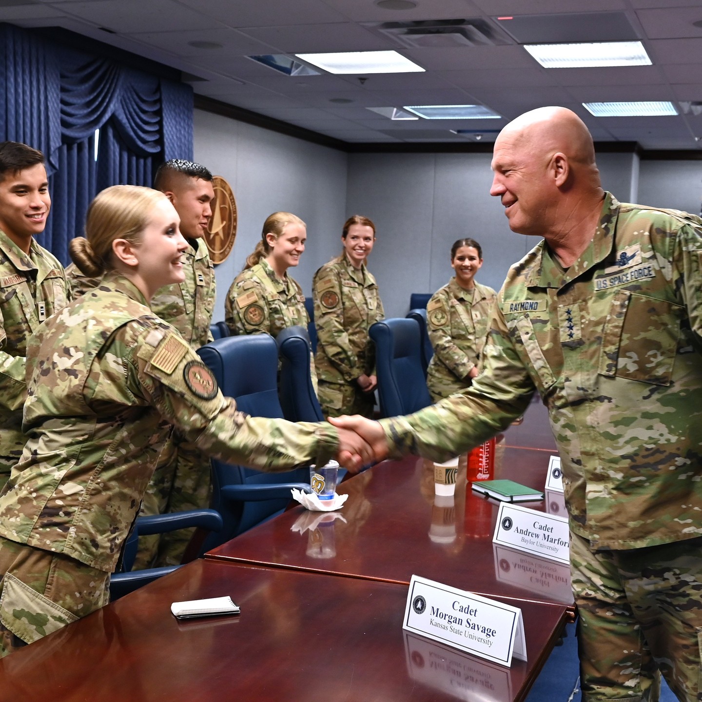 Cadet shaking hands with Gerenal Raymond