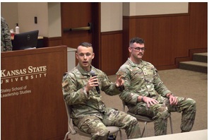 Two second lieutenant talking in front of wing