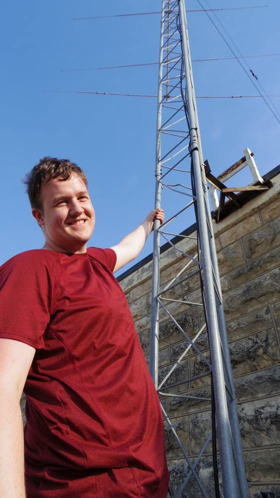 Reid Sayler hanging on the tower