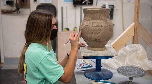K-State student working on pottery