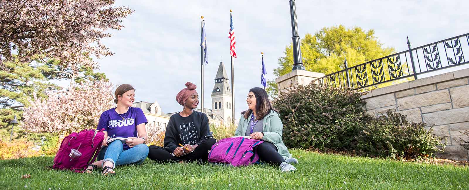 Students sitting outside on K-State campus