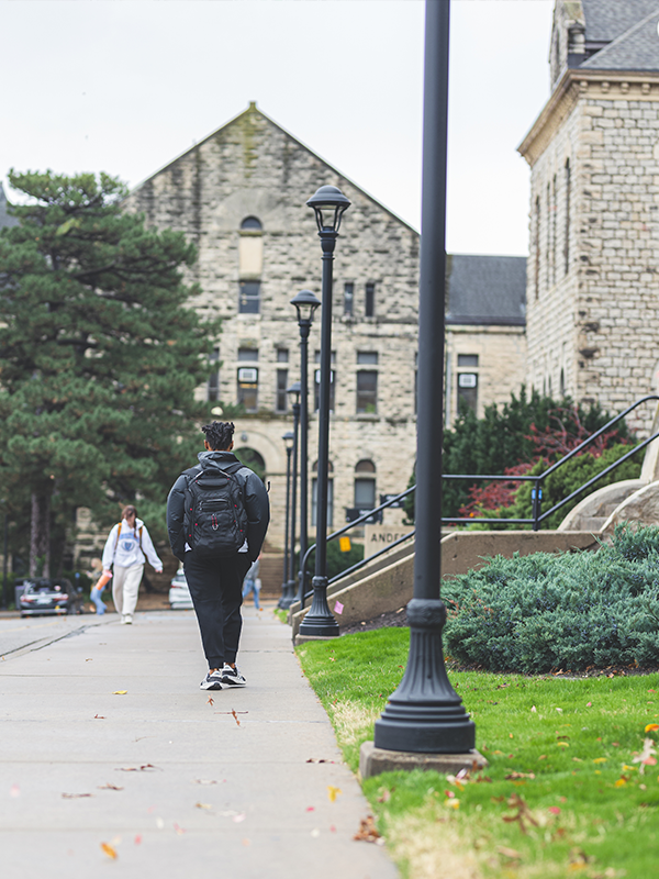Student walking past Anderson Hall