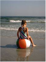 child sitting on ball