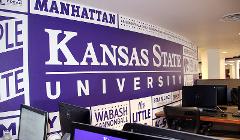 The renovated open computer lab features a wall with graphics and phrases symbolizing K-State and the Manhattan community.